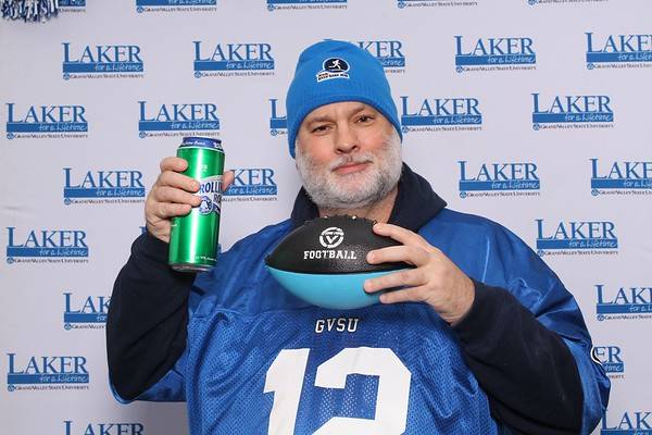 Alum with football and drink